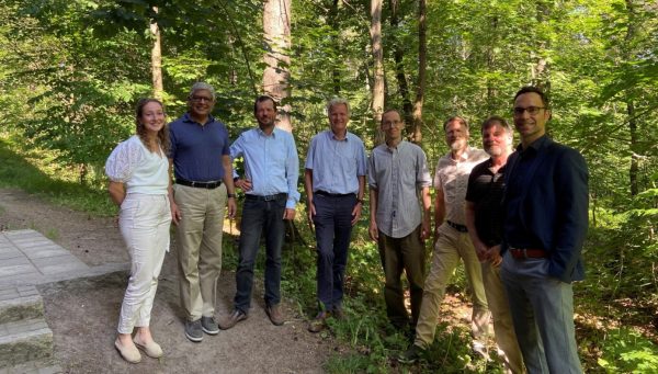 Group of scientists standing in the woods