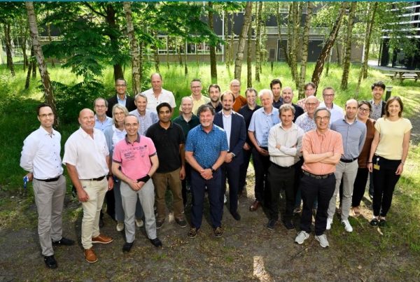 Group of scientists standing with trees in the backdrop